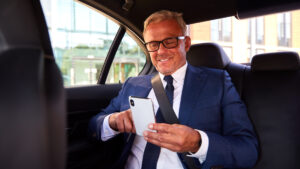 Businessman in back of car